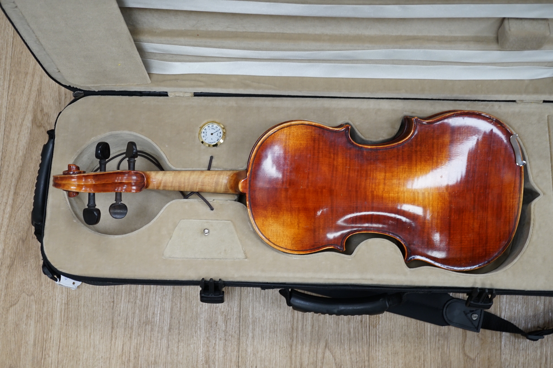 A Czechoslovakian student’s violin with Stradivarius label inside the body, length of body, 35.5cm, in a good modern case with fitted hygrometer